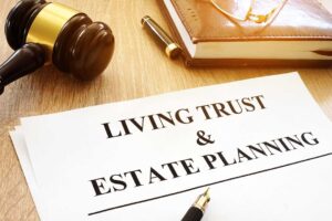 A person reviews a revocable trust document with a successor trustee at a home office desk.